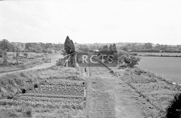 WOOL086 - Bloxham station (tracks removed) looking west from overbridge 23/6/65
