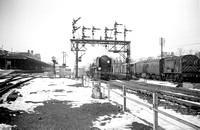 BALD232 - Cl BB No. 34050 'Royal Observer Corps' passing under the signal gantry at the east end of Basingstoke station c 1960s